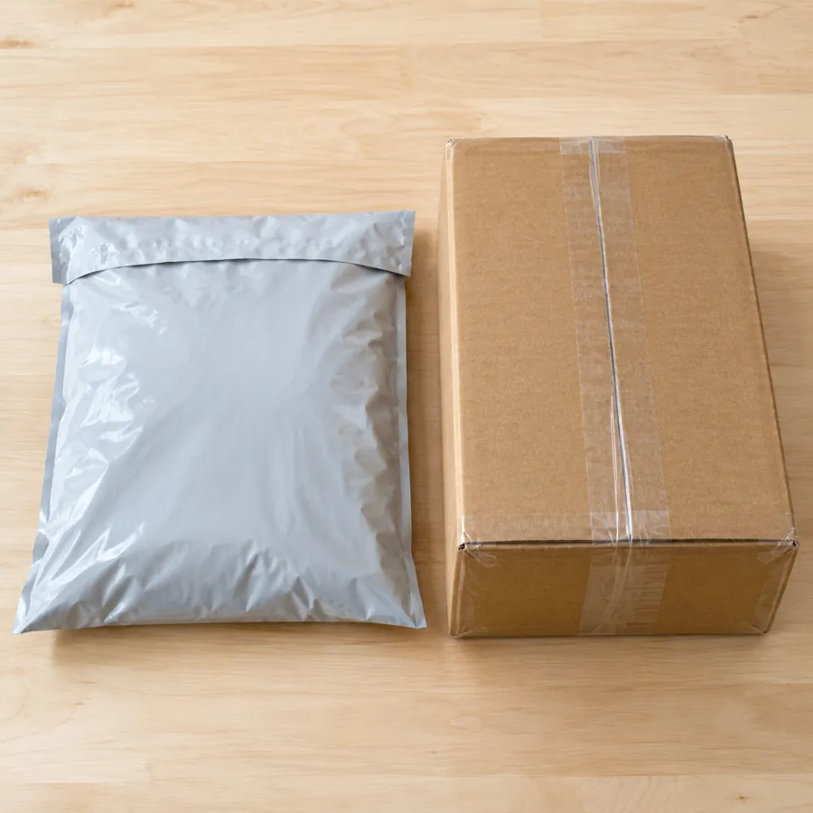 Sealed poly mailer and taped cardboard box side by side