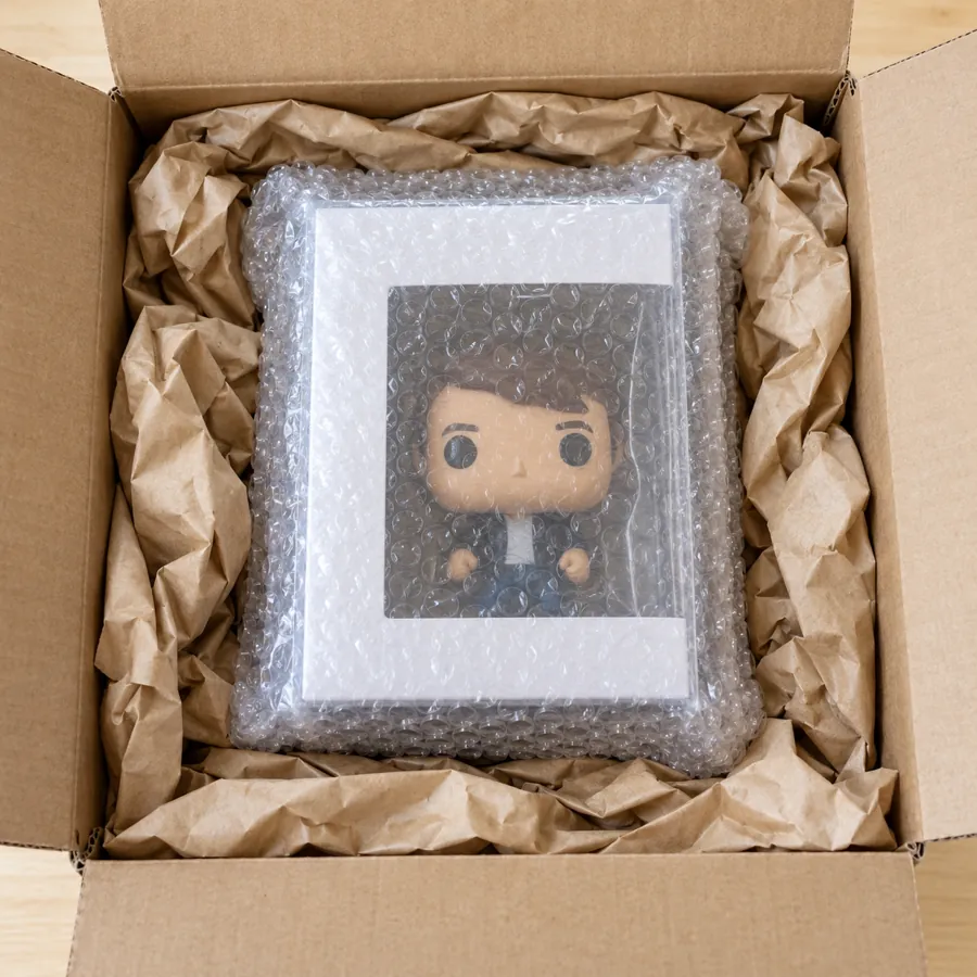 Protected Pop box wrapped in bubble wrap, centered in a shipping box with crumpled kraft paper around it